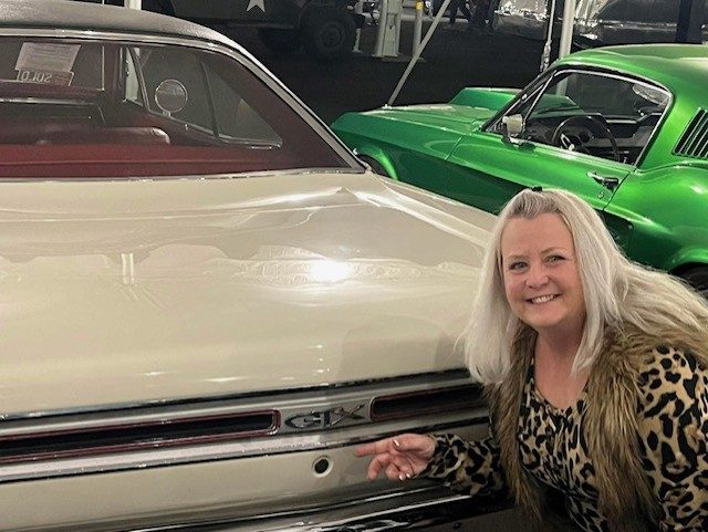 Annie with classic GTX muscle car